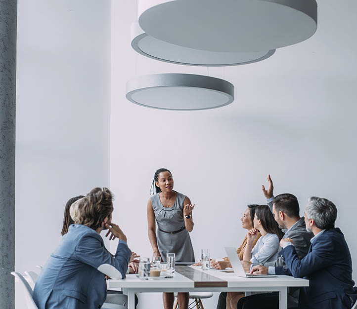 Shot of a businesswoman giving a presentation in the office board room. Group of business persons in business meeting. Group of entrepreneurs on meeting in board room. Corporate business team on meeting in the office.