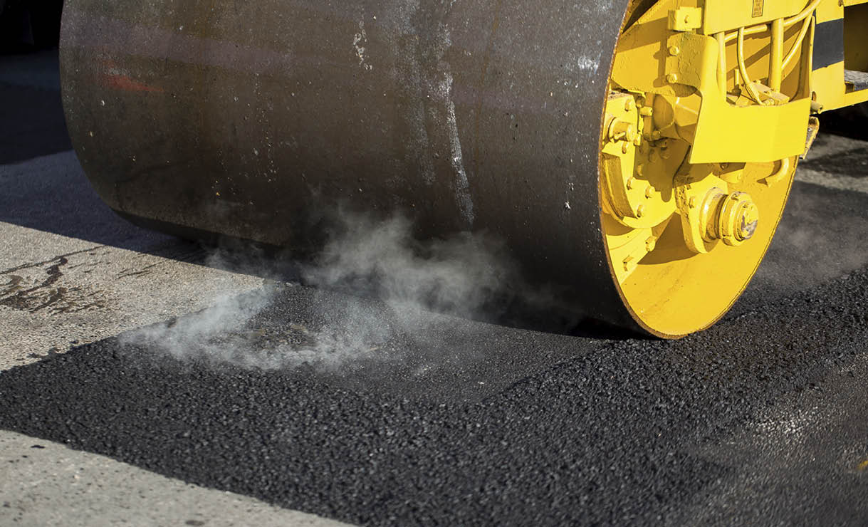 Road roller compacting asphalt
