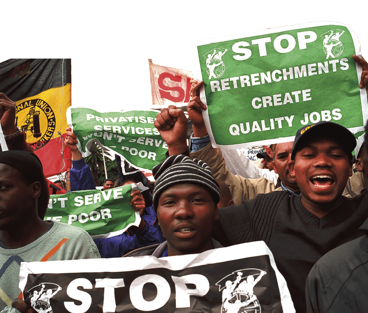 CAPE TOWN, SOUTH AFRICA - OCTOBER 1: People shout and carry signs during a demonstration against privatization and poverty on October 1, 2002 in central Cape Town, South Africa. The SA Trade Unions (COSATU) staged a two-day demonstration against the (ANC) African National Congress governments privatization of state companies economic policies. South Africa's unemployment rate is about 40 percent and they are struggling with high inflation and a weak currency that is hurting the poor.  (Photo by Per-Anders Pettersson/Getty Images) 