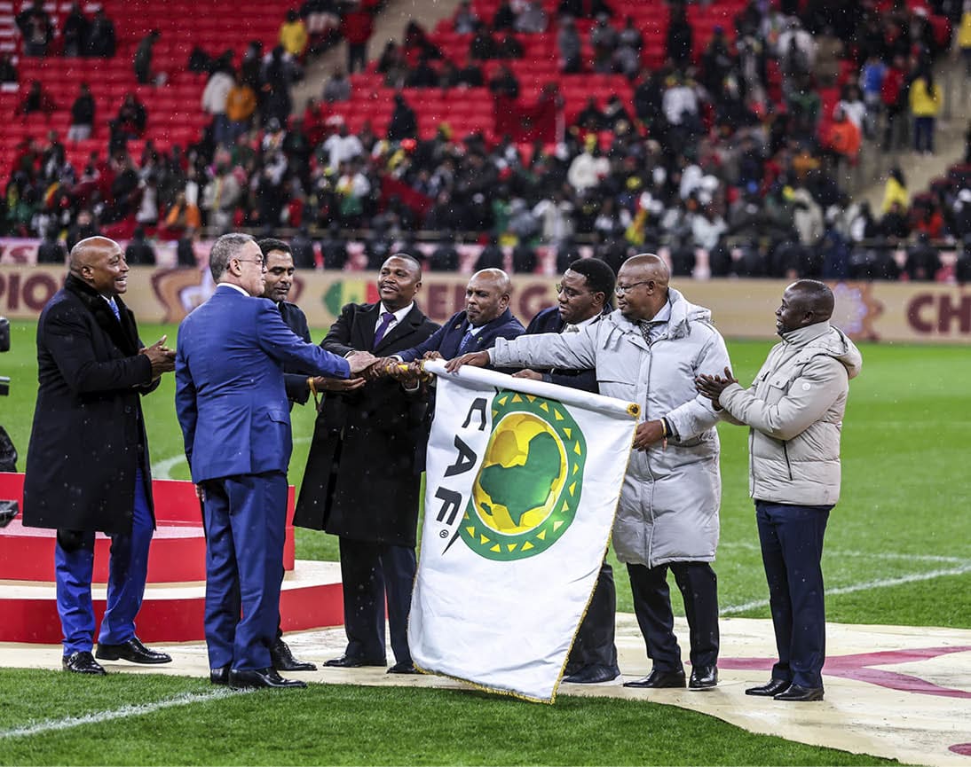 Rabat, Morocco - January 18: CAF President Patrice Motsepe gives the CAF flag to representants of Kenya, Tanzania and Uganda who host next AFCON during the Africa Cup Of Nations Final match between Senegal and Morocco at Prince Moulay Abdellah Stadium on January 18, 2026 in Rabat, Morocco. (Photo by Torbjorn Tande/DeFodi Images/DeFodi via Getty Images)