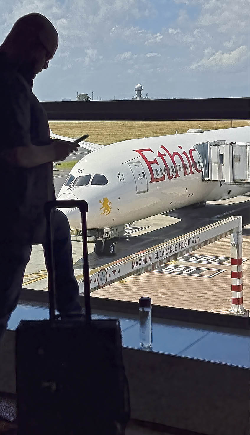 CAPE TOWN, SOUTH AFRICA - DECEMBER 1: Passengers wait to board Ethiopian Airlines flight ET 846, one of the few international flights leaving the country's second busiest airport after other flights were cancelled, on December 1, 2021 in Cape Town, South Africa. The South African government says the country, which just recently re-opened to international tourism, is bearing the brunt of publicly announcing the new COVID-19 Omicron variant, as other countries placed it on the red list. (Photo by David Silverman/Getty Images)