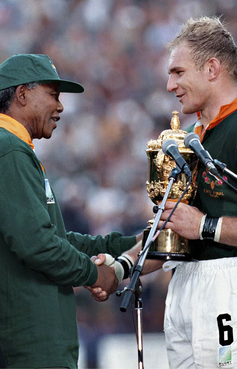 SOUTH AFRICA - JUNE 24: South African president Nelson Mandela, dressed in a No 6 Springbok jersey, congratulates the Springbok captain Francois Pienaar after South Africa beat the All Blacks by 15-12 to win the 1995 Rugby World Cup.  (Photo by Media24/Gallo Images/Getty Images)