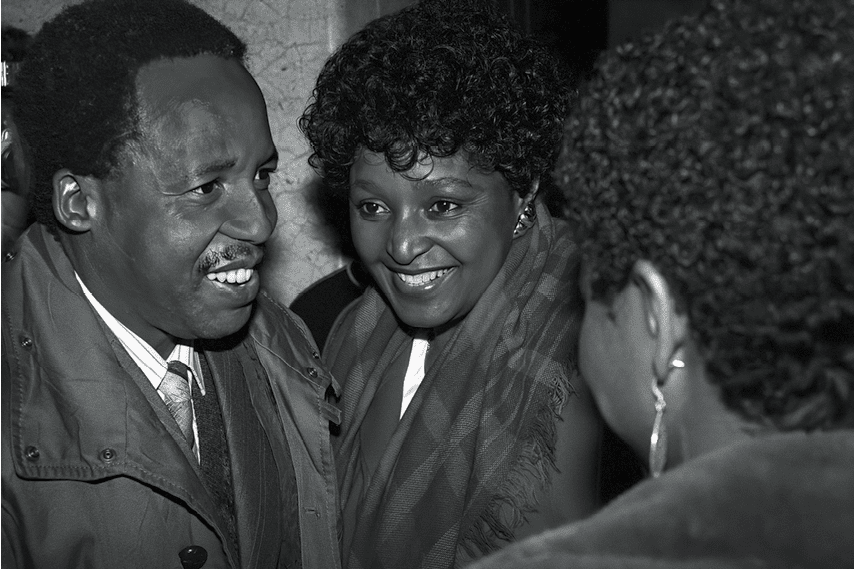 STOCKHOLM, SWEDEN - MARCH 13:  (EDITORS NOTE: Image has been converted to black and white. Color version available.)   Winnie Mandela speaks to Chris Hani at the Swedish parliament while on a five-day state visit, with husband Nelson Mandela, to Sweden on March 13, 1990, in Stockholm, Sweden. Mr. Mandela was released from prison on February 11, 1990. The ANC freedom fighter was in prison for 27 years. One of his first foreign visits was to Sweden to meet Oliver Tambo who served as the ANC president from 1967 to 1991. Mr. Mandela later became the first democratically elected President of South Africa after the first multiracial democratic elections in April 1994. Mr. Mandela retired after one term in 1999. Mr. Mandela died in 2013. Chris Hani was leader of the SA communist party, and the chief of staff for uMkhonto we Sizwe, the armed wing of ANC. He was assassinated on 10 April 1993. Winnie Mandela died in 2018. (Photo by Per-Anders Pettersson/Getty Images)