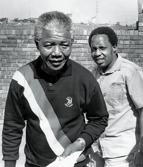 SOUTH AFRICA - 30 September 1990 (SOUTH AFRICA OUT): ANC deputy president Nelson Mandela leads Umkhonto we Sizwe chief of staff Chris Hani to face the media at the Mandela home in Orlando West yesterday. Hani said MK would continue to recruit cadres. (Photo by Linden Birns/Business Day/Gallo Images/Getty Images)