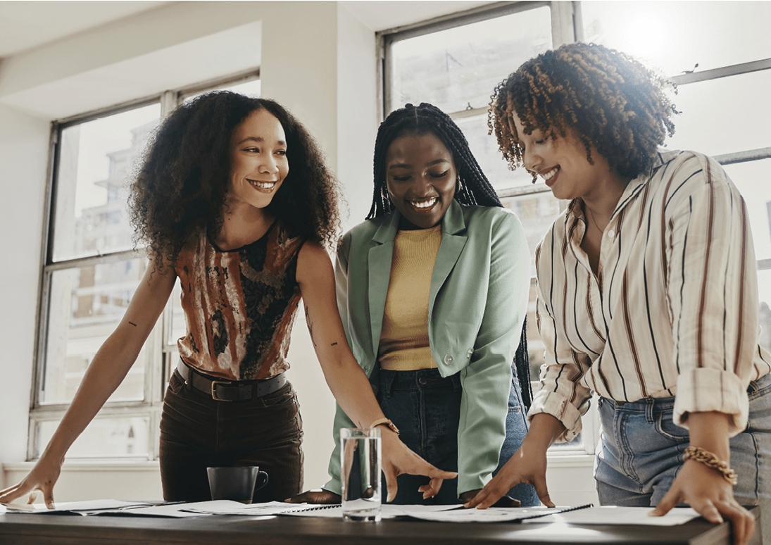 Teamwork, collaboration and planning black women with documents, paperwork or design strategy in office. Business startup, gender equality and marketing ideas of diversity people in workspace meeting