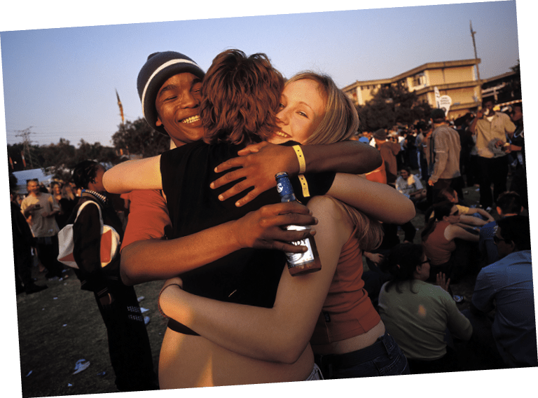 JOHANNESBURG, SOUTH AFRICA - MAY 28: (.) Unidentified youths socialize at a yearly youth festival May 28, 2002 in Auckland Park, a suburb in Johannesburg, South Africa. Eight years into democracy, the white youth of South Africa has to compete with a growing black middle class and elite for jobs and prosperity. Some whites that were rewarded in the old system have problems to adjust to competing and sharing the country's wealth with the black populationt. (Photo by Per-Anders Pettersson/Getty Images)      