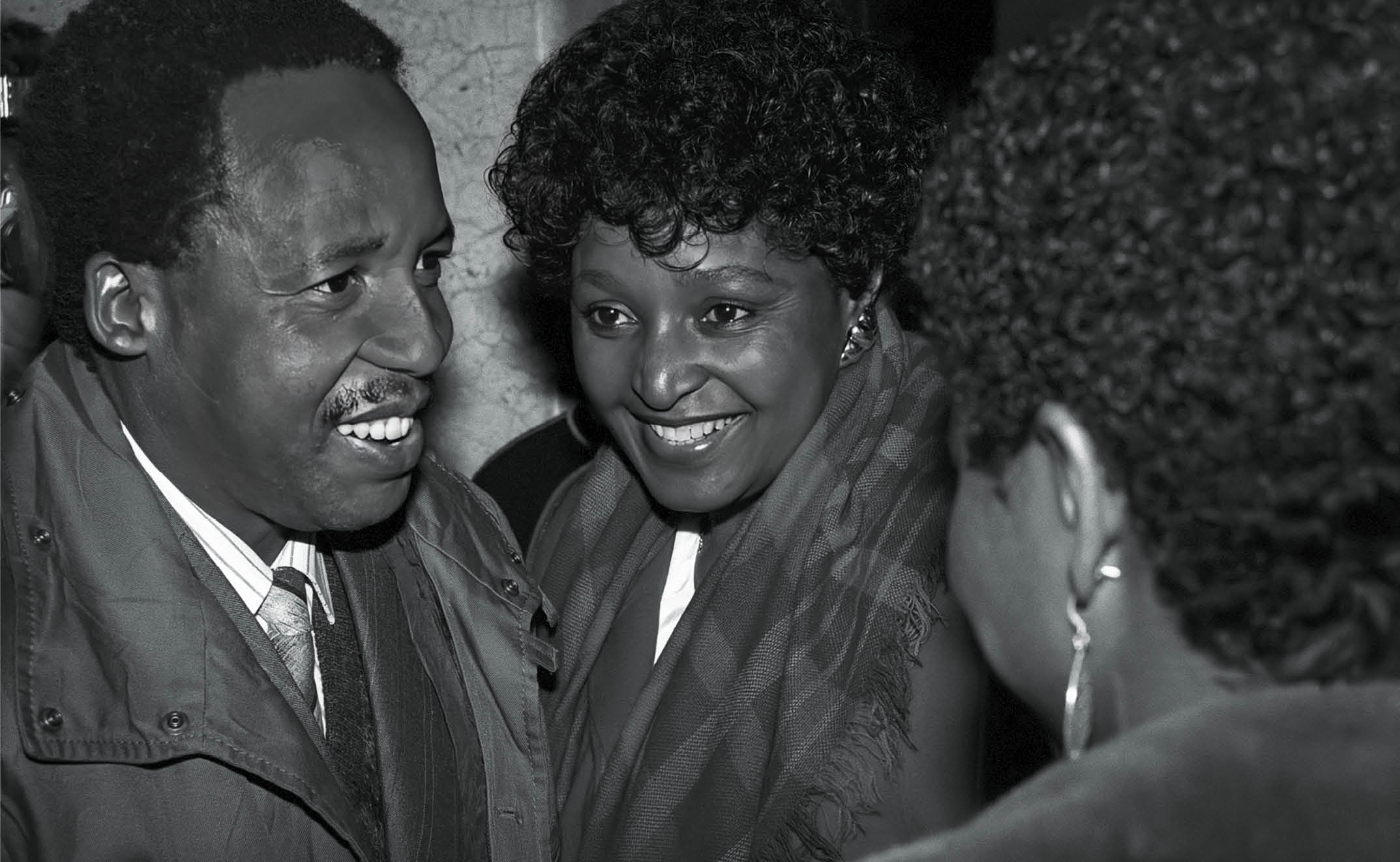 STOCKHOLM, SWEDEN - MARCH 13:  (EDITORS NOTE: Image has been converted to black and white. Color version available.)   Winnie Mandela speaks to Chris Hani at the Swedish parliament while on a five-day state visit, with husband Nelson Mandela, to Sweden on March 13, 1990, in Stockholm, Sweden. Mr. Mandela was released from prison on February 11, 1990. The ANC freedom fighter was in prison for 27 years. One of his first foreign visits was to Sweden to meet Oliver Tambo who served as the ANC president from 1967 to 1991. Mr. Mandela later became the first democratically elected President of South Africa after the first multiracial democratic elections in April 1994. Mr. Mandela retired after one term in 1999. Mr. Mandela died in 2013. Chris Hani was leader of the SA communist party, and the chief of staff for uMkhonto we Sizwe, the armed wing of ANC. He was assassinated on 10 April 1993. Winnie Mandela died in 2018. (Photo by Per-Anders Pettersson/Getty Images)