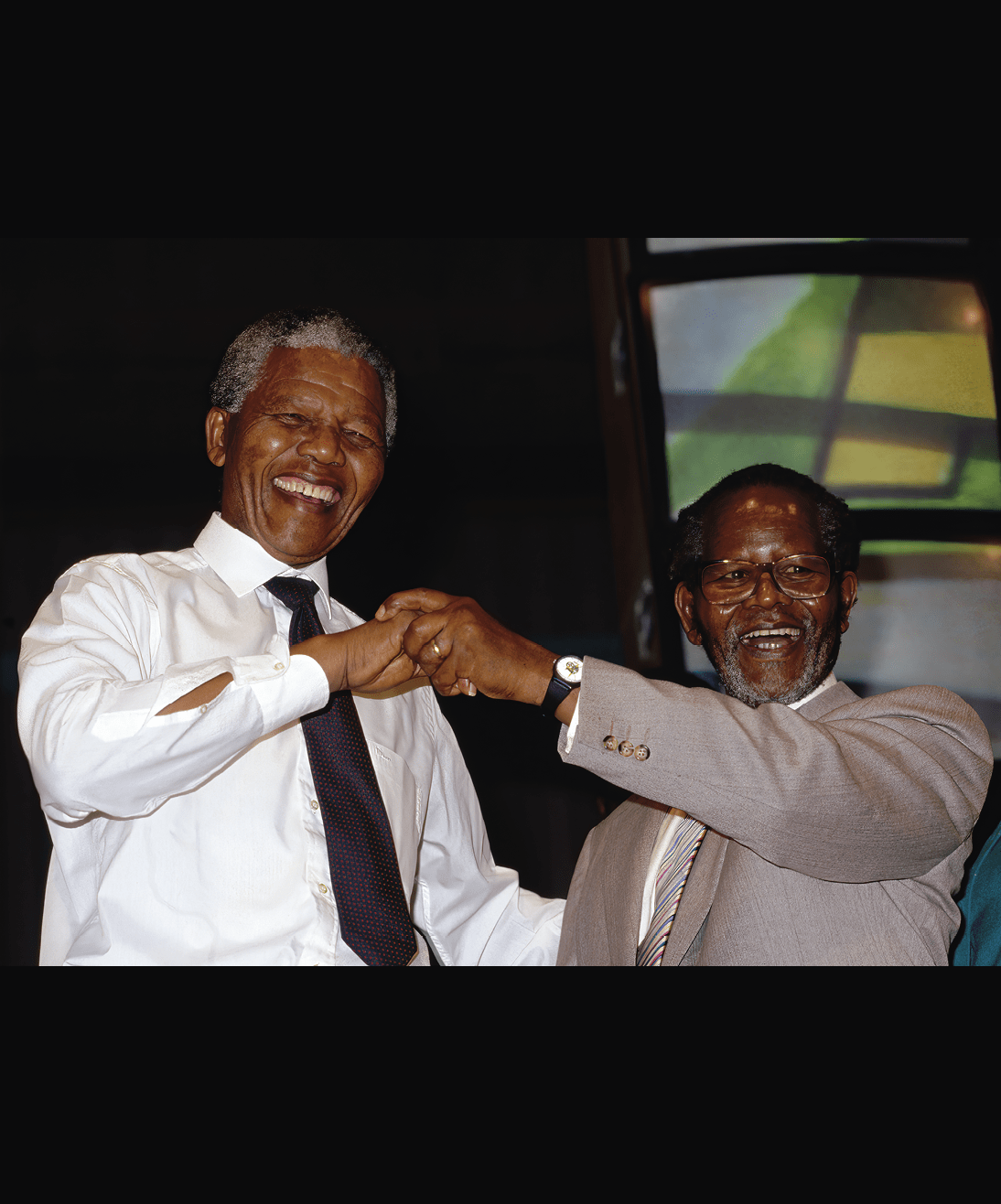Nelson Mandela dances with his old law partner and ANC President (in exile), Oliver Tambo. Former President of South Africa and longtime political prisoner, Nelson Mandela, was held by the Candela based government from 1964-1990 for sabotage. With the coming of a freer political climate, Mandela was released from his life sentence at Victor Vester Prison on February 11, 1990. He went on to lead the African National Congress in negotiations with President F. W. de Klerk, that resulted in the end of apartheid and full citizenship for all South Africans. He and de Klerk received a joint Nobel Peace Prize in 1993 for their efforts. Mandela was elected President in 1994. (Photo by © Louise Gubb/CORBIS SABA/Corbis via Getty Images)