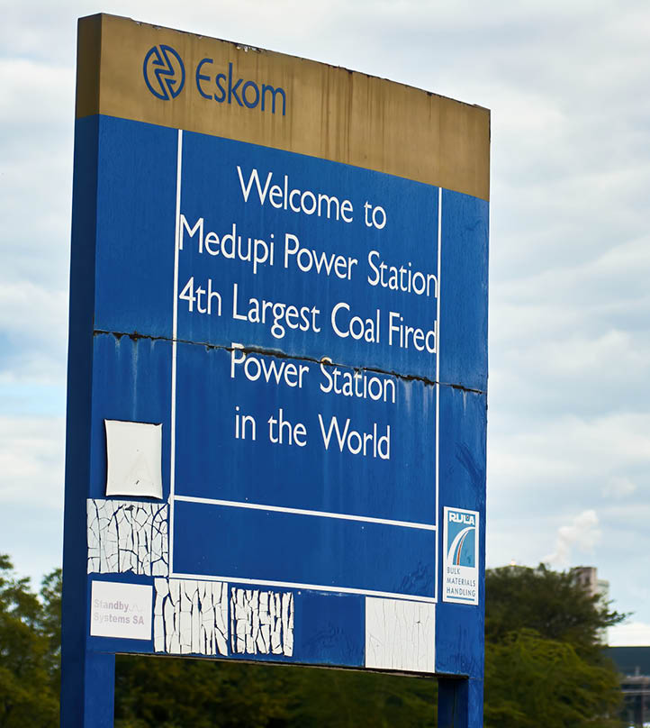A sign outside the Eskom Holdings SOC Ltd. Medupi coal-fired power station in Lephalale, South Africa, on Thursday, May 19, 2022. South Africas Eskom is increasing power cuts to prevent a total collapse of the grid as issues grow from lack of imports to breakdowns at its coal-fired plants. Photographer: Waldo Swiegers/Bloomberg via Getty Images
