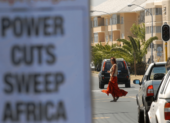 Traffic lights were not working in Cape Town, 21 January 2008, as a result, of power cuts, or “load shedding", as it is called, by the national electicity supplier, ESKOM. ESKOM has come under harsh criticism, for failing to plan for the country's growth in demand for electicity, that has accompanied the country's economic growth. These breaks in power supply have happened all over the country, and according to the newspaper poster, all over the African continent.    AFP PHOTO / RODGER BOSCH (Photo credit should read RODGER BOSCH/AFP via Getty Images)