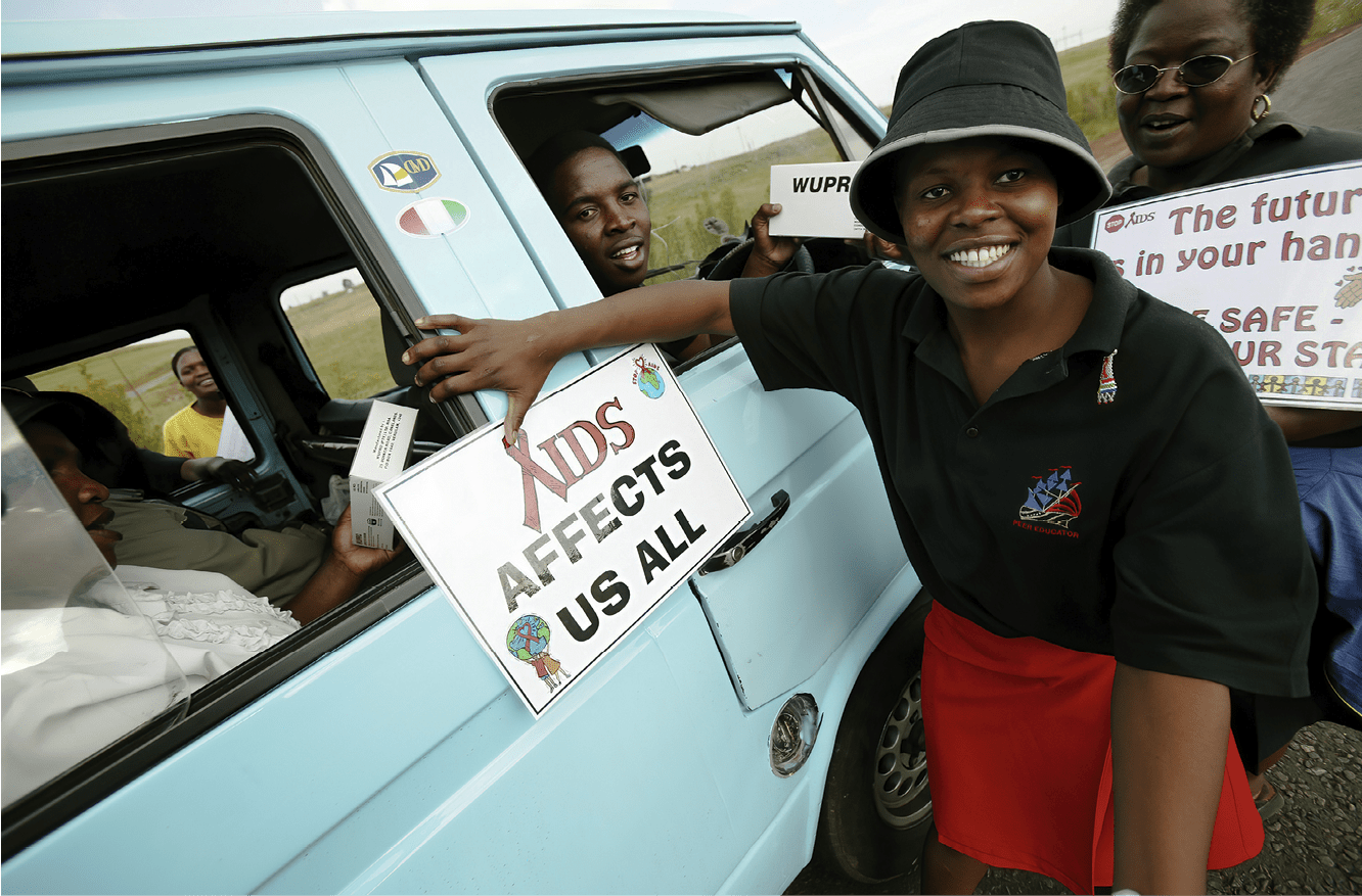 WITBANK, GAUTENG, SOUTH AFRICA - APRIL 2: (SOUTH AFRICA OUT)  Women from the mining community pass out condoms and educational leaflets April 2, 2004 in the Witbank District in the Gauteng Province of South Africa. The women come out every Friday to promote safe sex. Some of the women are sex workers and have been taking responsibility for their own safety. Getty Images is partnering with the Global Business Coalition on HIV/AIDS ongoing projects.  (Photo by Brent Stirton/Getty Images)