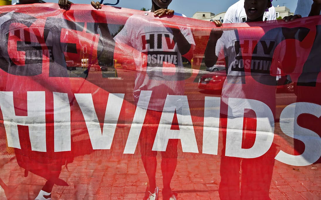 JOHANNESBURG, SOUTH AFRICA - MARCH 22: (SOUTH AFRICA OUT) Doctors Without Borders supporters march in protest to the American Consulate on March 22, 2012 in Johannesburg, South Africa. Protestors gathered to bring forth a memorandum regarding a lack of funding from foundations, like the US based Global Fund, towards the fight against HIV/AIDS. (Photo by Foto24/Gallo Images/Getty Images)