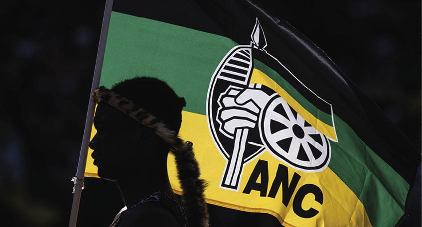 JOHANNESBURG, SOUTH AFRICA - MAY 25: A performer holds an ANC flag while listening to President of the ruling African National Congress (ANC) and South African President, Cyril Ramaphosa speak during the ANC Siyanqoba Rally held at FNB Stadium on May 25, 2024 in Johannesburg, South Africa. South Africa's national and provincial elections will be held on 29 May 2024 to elect a new National Assembly and provincial legislature in each of the nine provinces. (Photo by Chris McGrath/Getty Images)