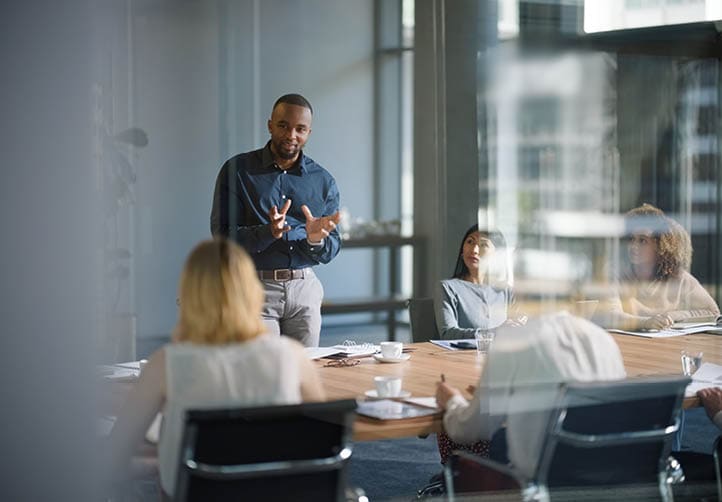 Businessman, meeting and discussion with office, boardroom and collaboration or workshop. Leader, training and presentation for mentor, coaching and strategy for teamwork and planning with startup