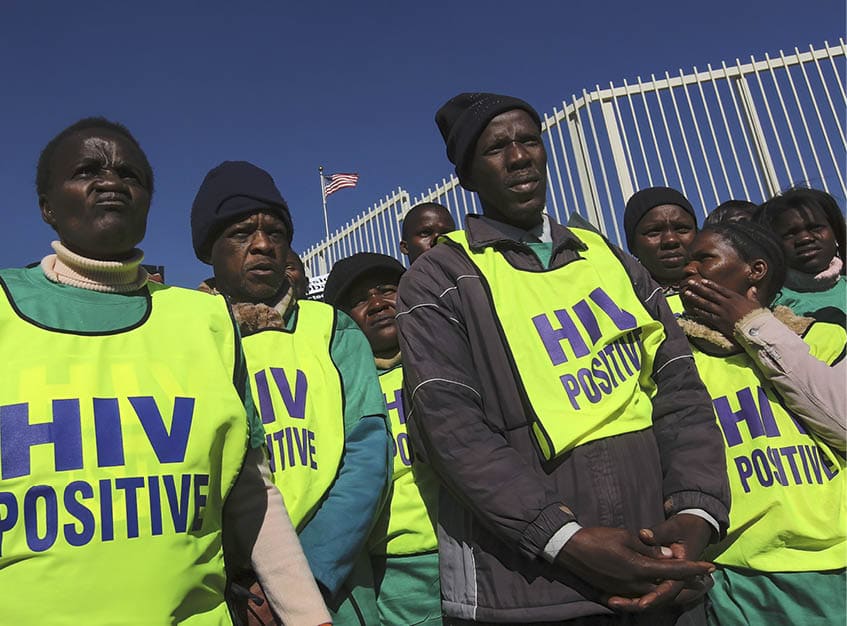 SANDTON, SOUTH AFRICA - JUNE 17: HIV/AIDS activists demonstrate in front of the American consulate on June 17, 2010 in the Johannesburg suburb of Sandton, South Africa. More than a thousand demonstrators marched demanding that the US government increase its funding for anti-retroviral drugs (ARVs) to treat Africans with HIV/AIDS. South Africa has the most people living with HIV of any nation in the world.  (Photo by John Moore/Getty Images)