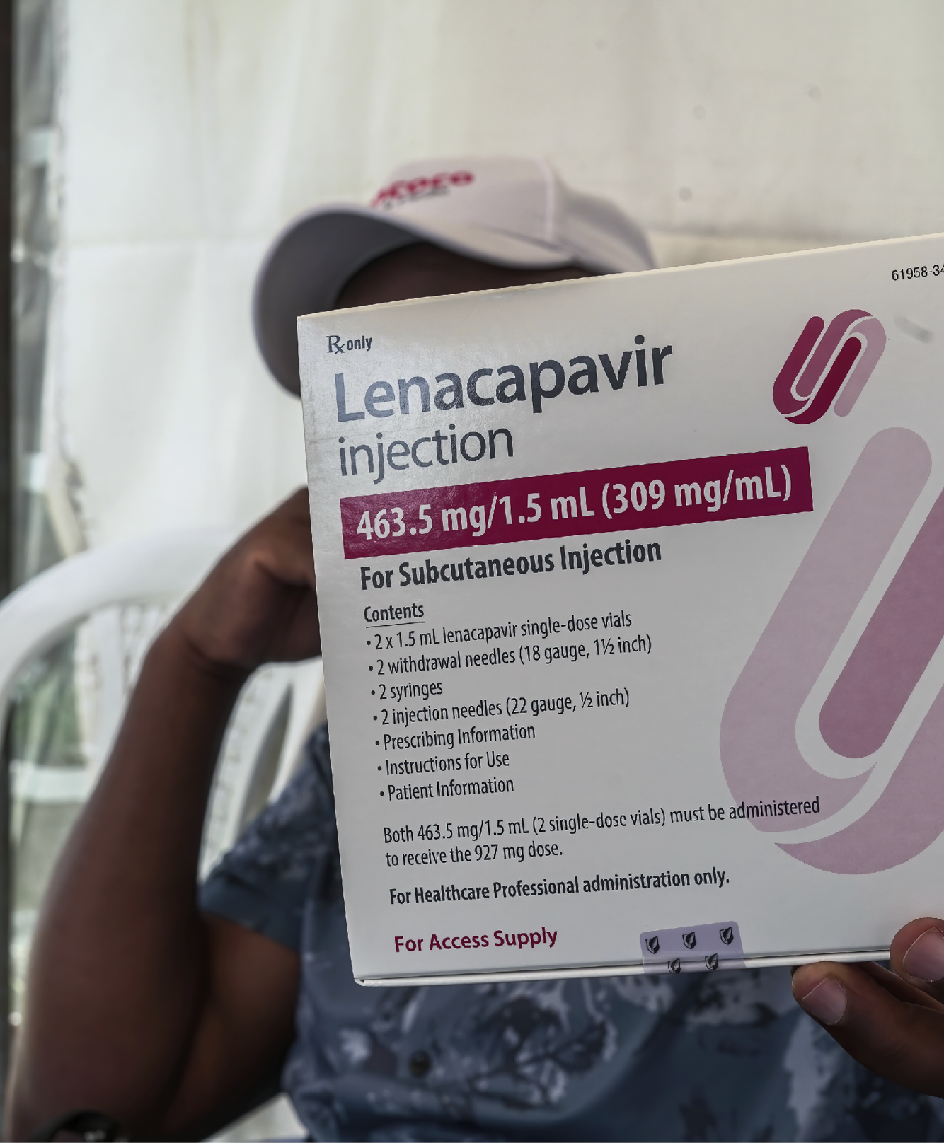 NAKURU, KENYA - 2026/03/26: A man holds a packaging containing lenacapavir, a long-acting HIV pre-exposure prophylaxis (PrEP) injection, during the drug's rollout in Nakuru. Kenya is rolling out Lenacapavir, a long-acting injectable pre-exposure prophylaxis (PrEP) drug that provides up to six months of protection with a single injection. (Photo by James Wakibia/SOPA Images/LightRocket via Getty Images)
