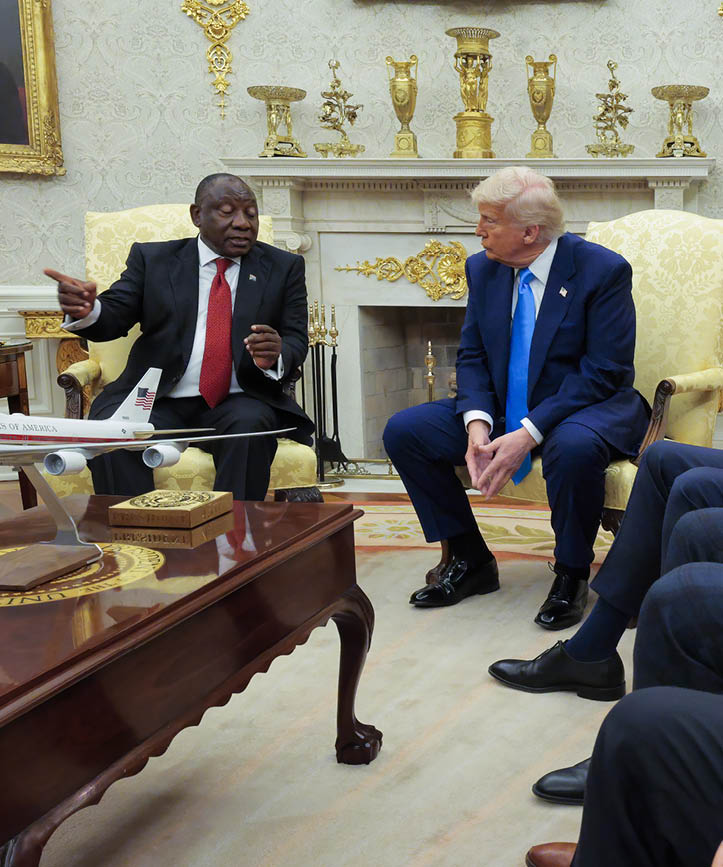 WASHINGTON, DC - MAY 21: President of South Africa Cyril Ramaphosa (L) speaks as U.S. President Donald Trump listens while (L-R) U.S. Vice President JD Vance, U.S. Defense Secretary Pete Hegseth and U.S. Secretary of Commerce Howard Lutnick look on during a meeting in the Oval Office of the White House on May 21, 2025 in Washington, DC. Relations between the two countries have been strained since Trump signed an executive order in February that claimed white South Africans are the victims of government land confiscation and race-based “genocide” while admitting some of those Afrikaners as refugees to the United States. Trump also halted all foreign aid to South Africa and expelled the country’s Ambassador to the U.S. Ebrahim Rasool. (Photo by Chip Somodevilla/Getty Images)