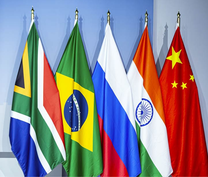 JOHANNESBURG, SOUTH AFRICA - AUGUST 22: The national flags of current BRICS members are displayed before the announcement that Argentina, Egypt, Ethiopia, Iran, the U.A.E. and Saudi Arabia will be joining the group during a press conference on the closing day of the BRICS summit at the Sandton Convention Center in the Sandton district of Johannesburg on August 24, 2023 in the Sandton district of Johannesburg, South Africa. The BRICS summit, held in South Africa between 22-24 August 2023. The BRICS group of major emerging economies is made up of Brazil, Russia, India, China and South Africa. The 15th BRICS Summit, an international relations conference, is being held in South Africa between August 22-24 2023 with the leaders expected to discuss the expansion of the BRICS group and a BRICS currency. It is the first in-person summit of the BRICS nations - Brazil, Russia, India, China and South Africa - since the Covid-19 pandemic. Russian President Vladimir Putin will not be attending the meetings in person due to the ICC, International Criminal Court issued warrant for alleged war crimes.  (Photo by Per-Anders Pettersson/Getty Images)