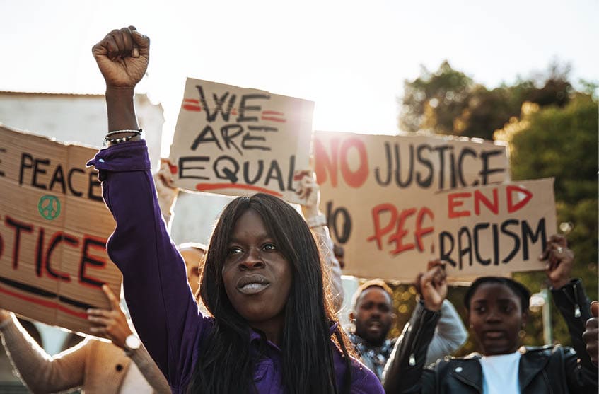 People united against racism. Anti-Racism protest. Protestors holding hand-made signs on cardboards.
