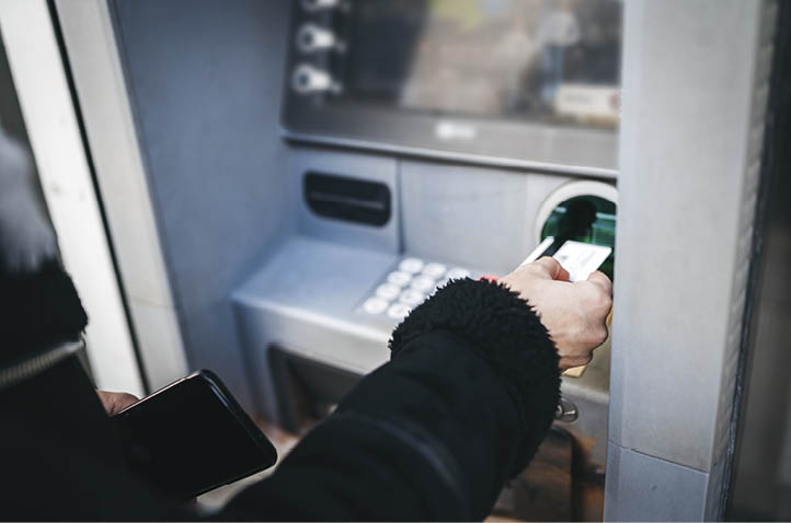 A woman uses an ATM
