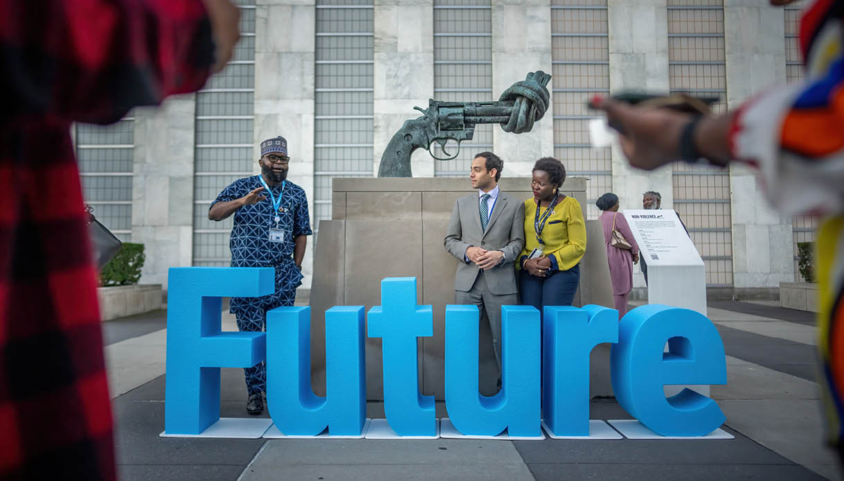 21 September 2024, USA, New York: Guests take pictures behind “Future" lettering on the artwork "Non Violence" by Swedish artist Carl Fredrik Reutersw rd before the start of the UN Future Summit at the United Nations in New York. At the summit, heads of state and government are to approve the United Nations Pact for the Future. Photo: Michael Kappeler/dpa (Photo by Michael Kappeler/picture alliance via Getty Images)